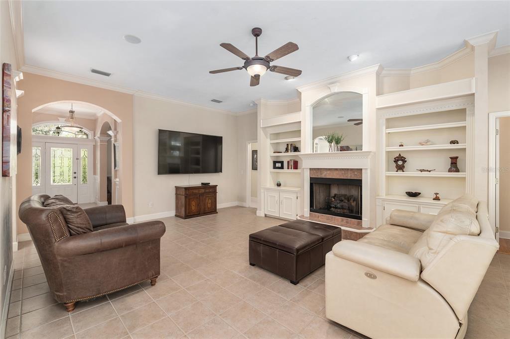 9513 Southwest 33 Lane Gainesville, FL 32608 - Photo 17 of 68 a living room with furniture a flat screen tv and a fireplace