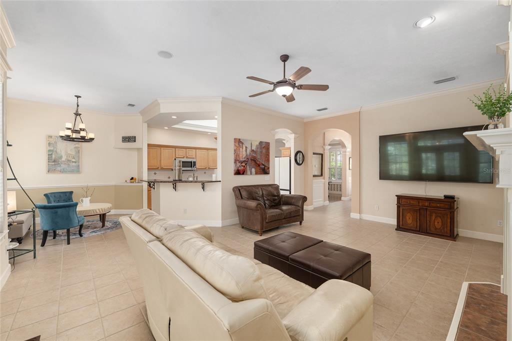 9513 Southwest 33 Lane Gainesville, FL 32608 - Photo 20 of 68 a living room with furniture a flat screen tv and kitchen view