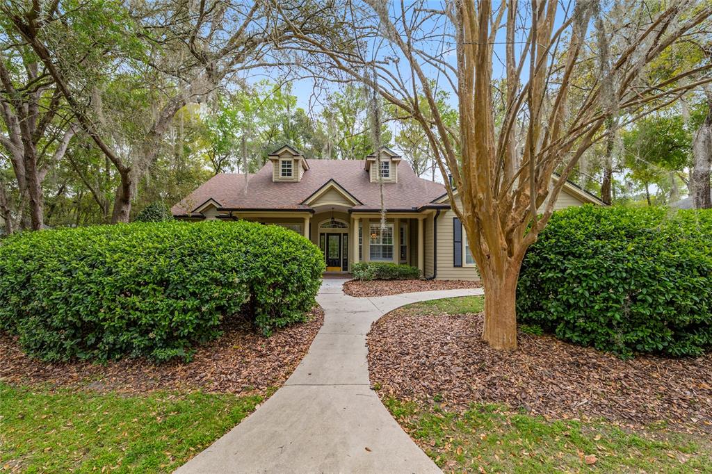 9513 Southwest 33 Lane Gainesville, FL 32608 - Photo 2 of 68 a front view of a house with a yard and trees