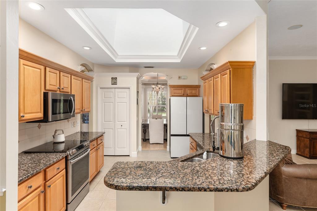 9513 Southwest 33 Lane Gainesville, FL 32608 - Photo 22 of 68 a kitchen with stainless steel appliances granite countertop sink stove refrigerator and cabinets