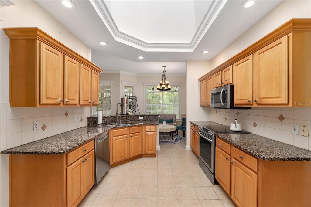 9513 Southwest 33 Lane Gainesville, FL 32608 - Photo 23 of 68 a kitchen with stainless steel appliances granite countertop a sink stove and cabinets