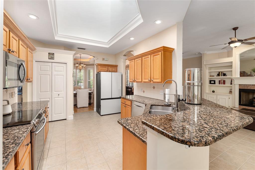 9513 Southwest 33 Lane Gainesville, FL 32608 - Photo 25 of 68 a kitchen with stainless steel appliances granite countertop a sink refrigerator and cabinets