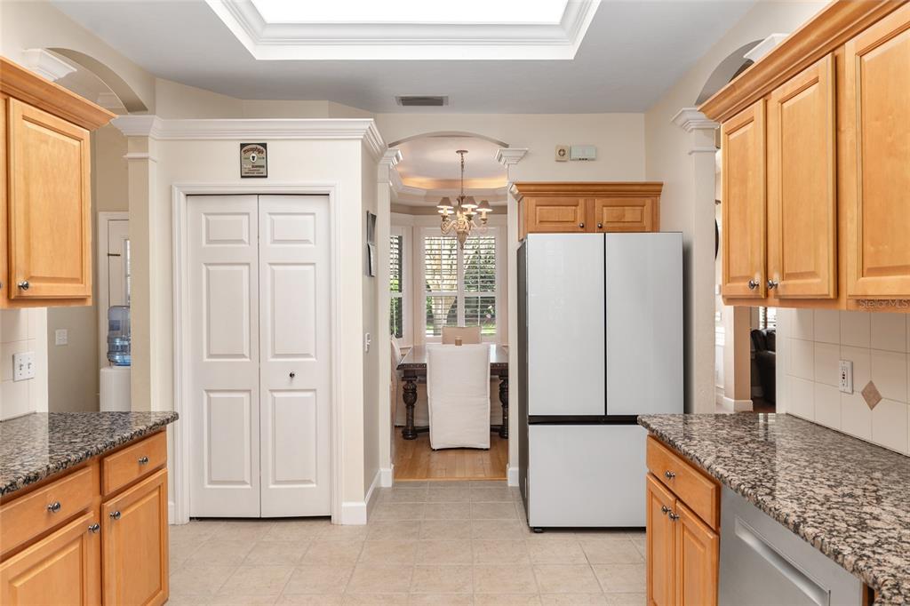 9513 Southwest 33 Lane Gainesville, FL 32608 - Photo 26 of 68 a kitchen with stainless steel appliances granite countertop a refrigerator a sink and white cabinets