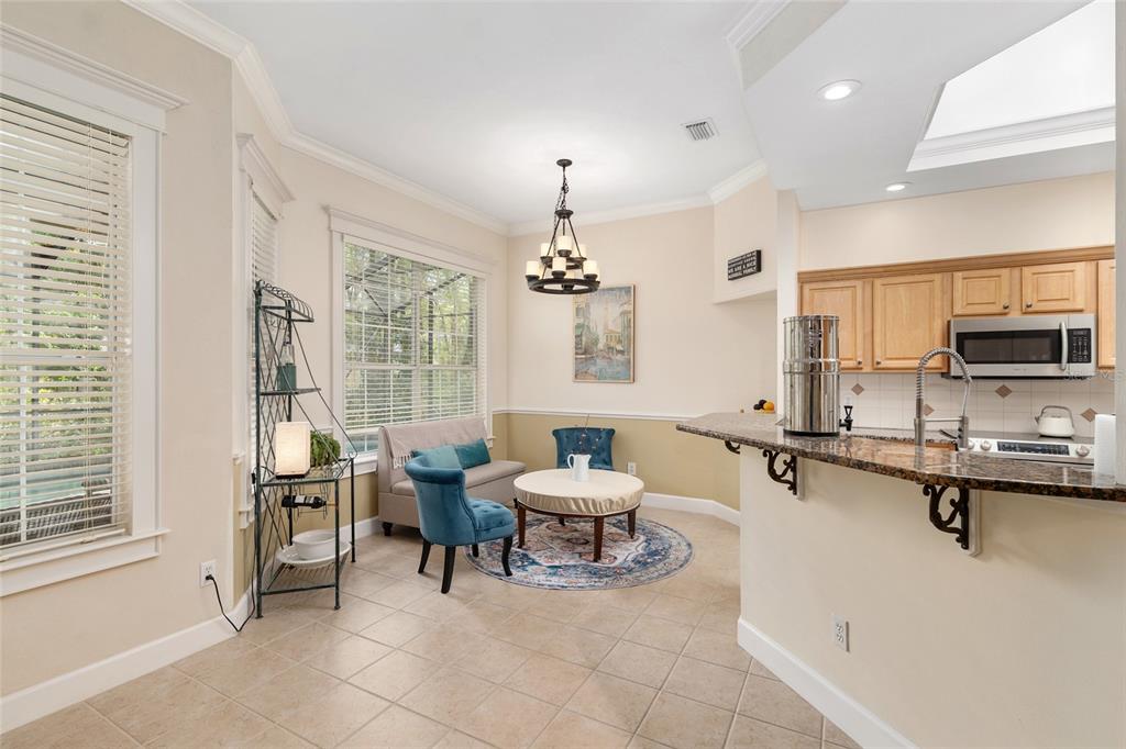 9513 Southwest 33 Lane Gainesville, FL 32608 - Photo 31 of 68 a living room with furniture a chandelier and a dining table