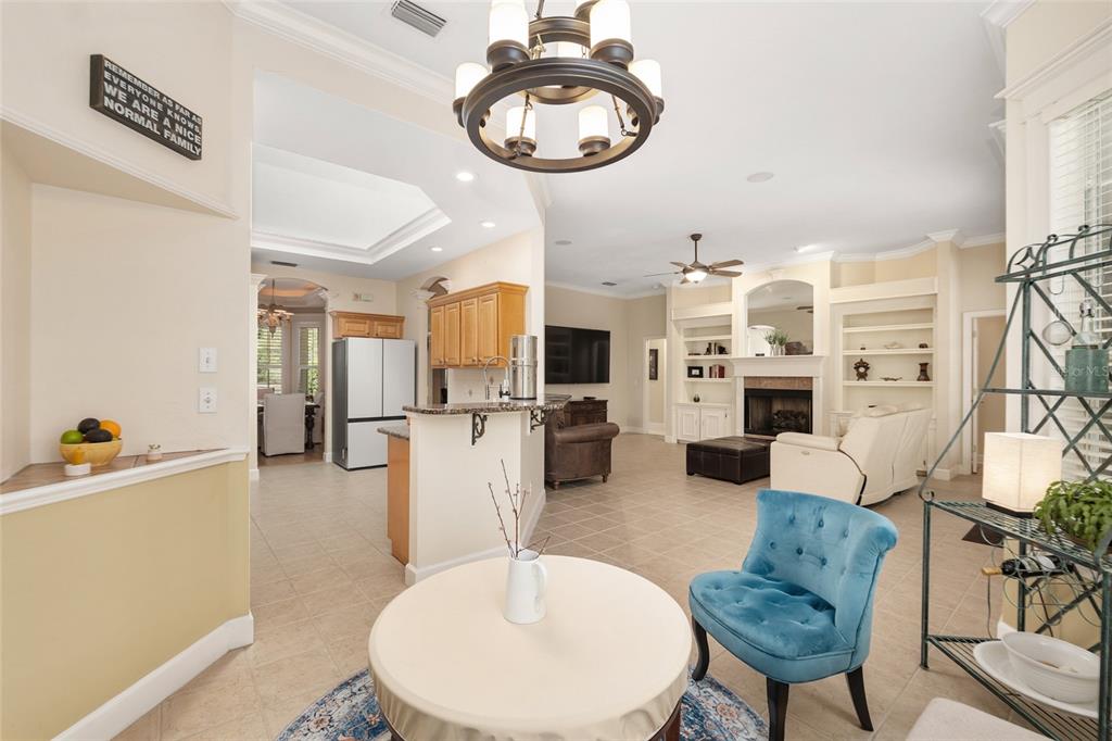 9513 Southwest 33 Lane Gainesville, FL 32608 - Photo 32 of 68 a living room with furniture kitchen view and a chandelier