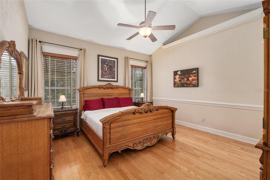 9513 Southwest 33 Lane Gainesville, FL 32608 - Photo 34 of 68 a bedroom with a bed and wooden floor