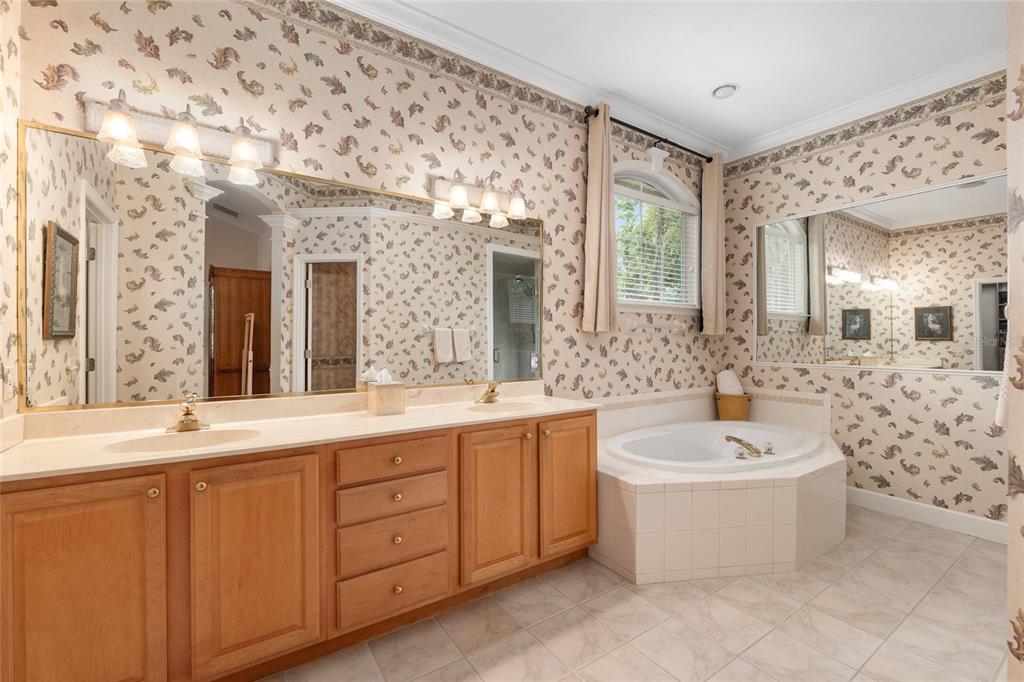 9513 Southwest 33 Lane Gainesville, FL 32608 - Photo 36 of 68 a spacious bathroom with a double vanity sink mirror and bathtub