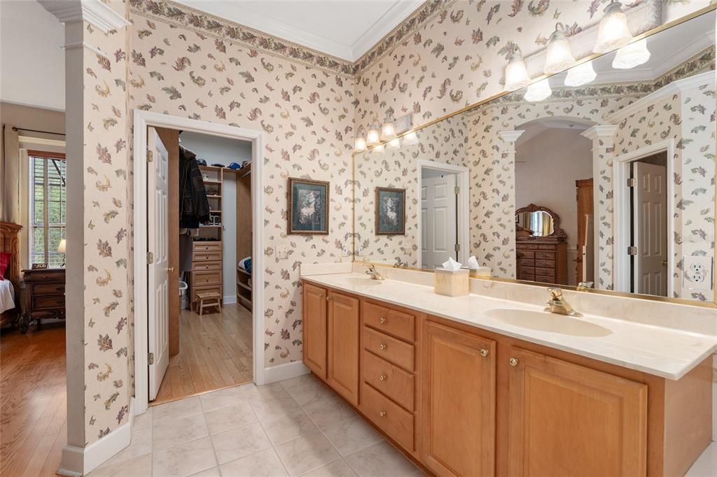 9513 Southwest 33 Lane Gainesville, FL 32608 - Photo 38 of 68 a spacious bathroom with a double vanity sink and a mirror
