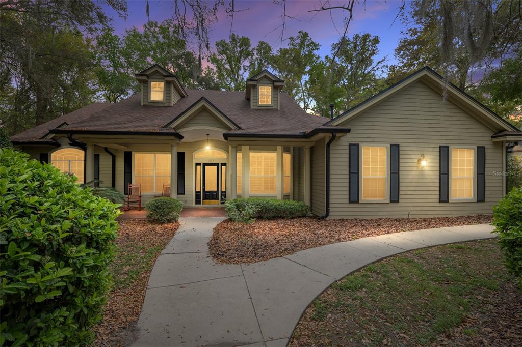 9513 Southwest 33 Lane Gainesville, FL 32608 - Photo 4 of 68 a front view of a house with a yard and outdoor seating