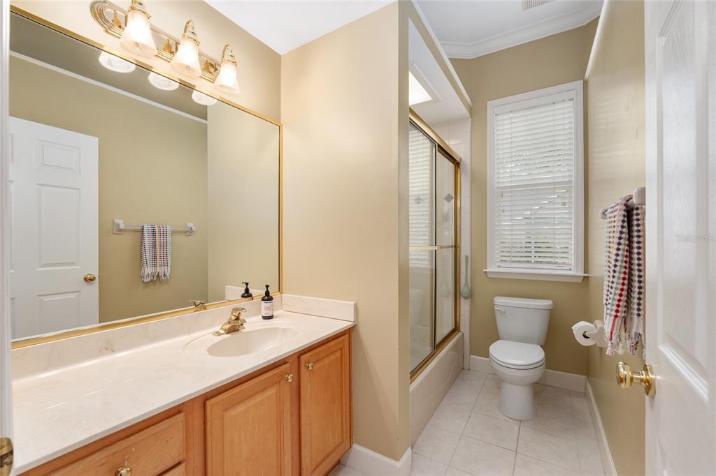 9513 Southwest 33 Lane Gainesville, FL 32608 - Photo 44 of 68 a bathroom with a sink a toilet a mirror and shower