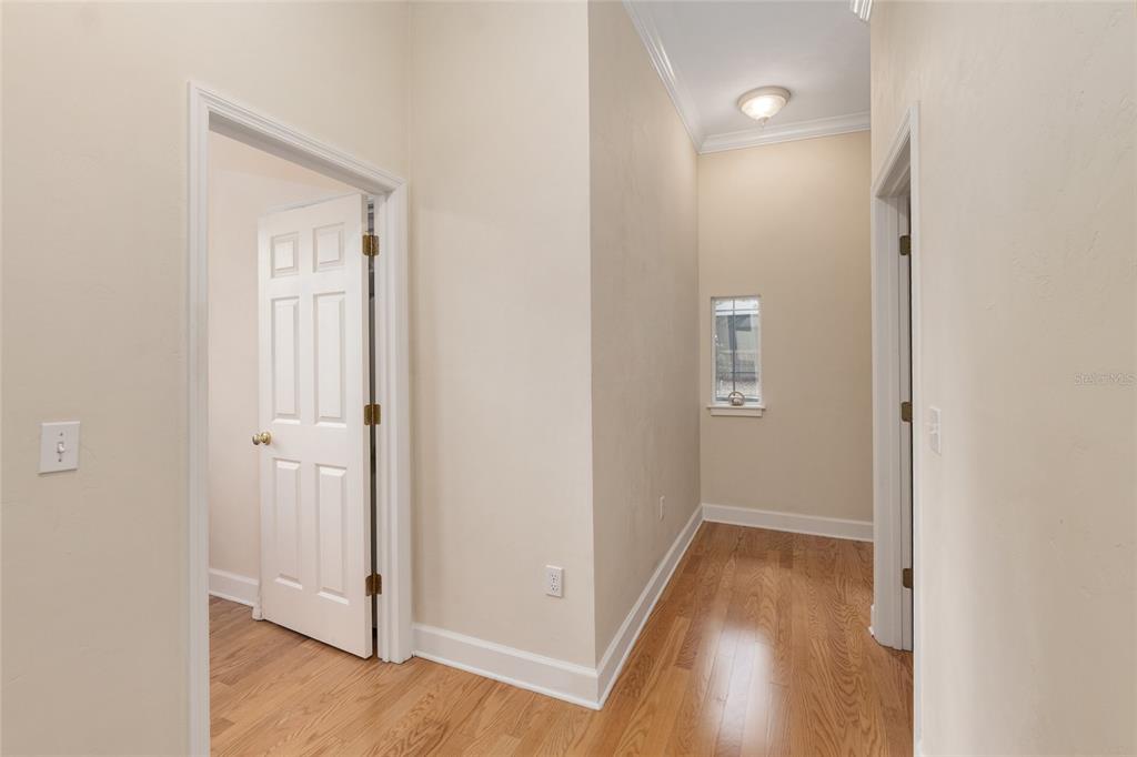 9513 Southwest 33 Lane Gainesville, FL 32608 - Photo 47 of 68 a view of a hallway with wooden floor