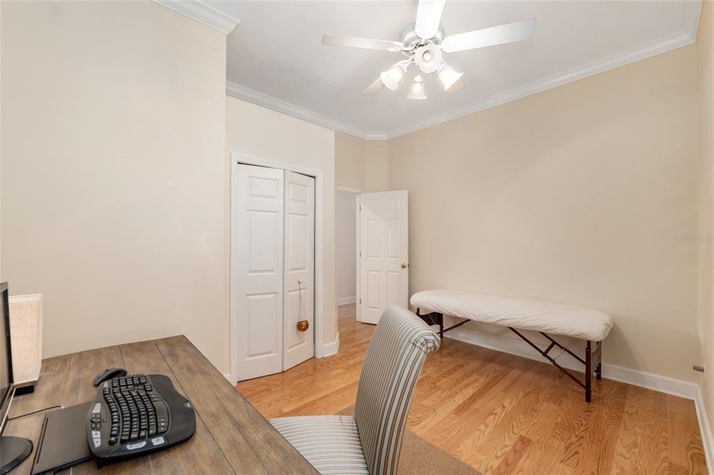 9513 Southwest 33 Lane Gainesville, FL 32608 - Photo 48 of 68 a bedroom with a bed and a chandelier