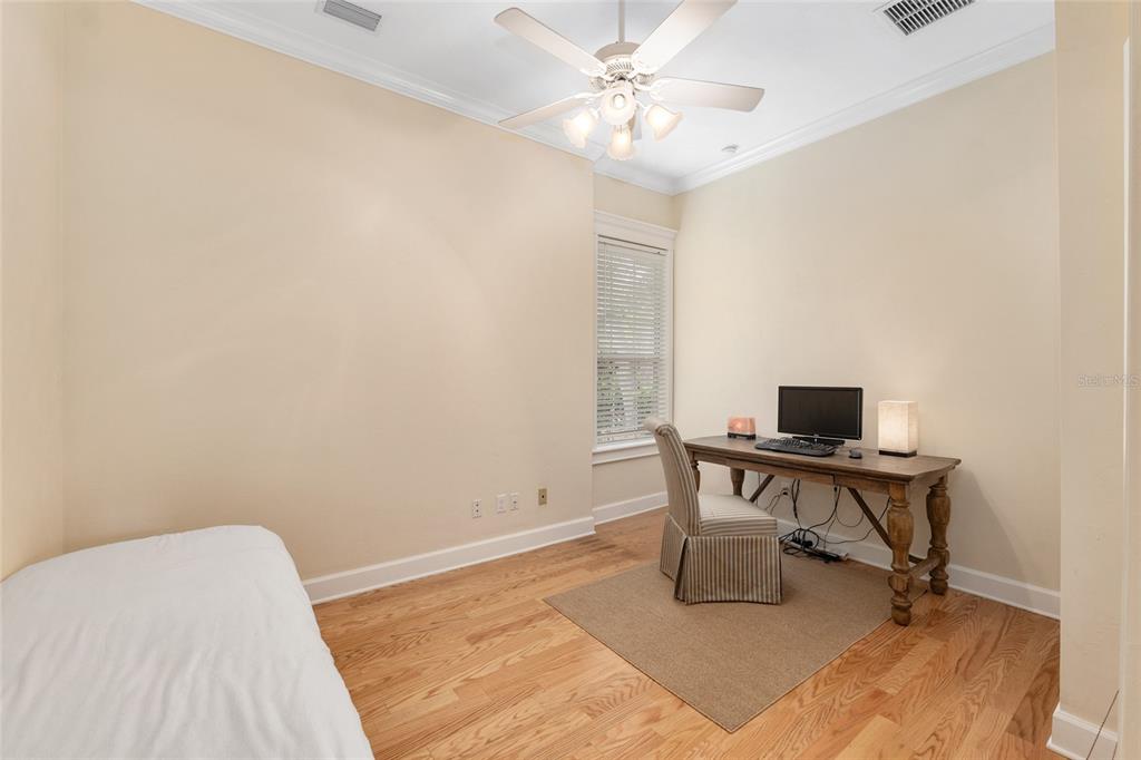 9513 Southwest 33 Lane Gainesville, FL 32608 - Photo 49 of 68 a view of a workspace with furniture and wooden floor