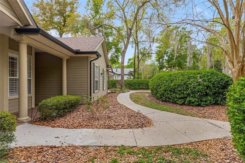 9513 Southwest 33 Lane Gainesville, FL 32608 - Photo 5 of 68 a view of a house with a yard and plants