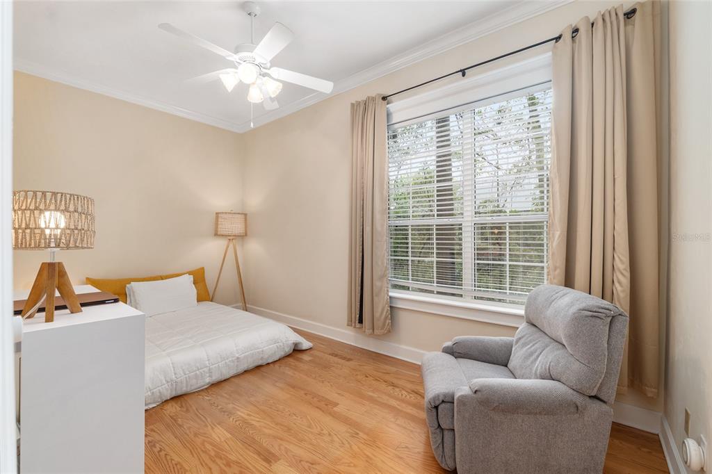 9513 Southwest 33 Lane Gainesville, FL 32608 - Photo 51 of 68 a bedroom with furniture and a large window