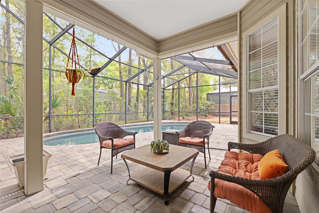 9513 Southwest 33 Lane Gainesville, FL 32608 - Photo 55 of 68 a living room with furniture and floor to ceiling windows