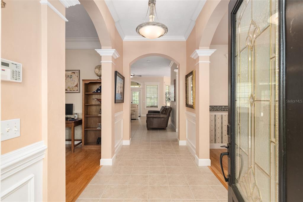 9513 Southwest 33 Lane Gainesville, FL 32608 - Photo 10 of 68 a view of a hallway with wooden floor and a livingroom