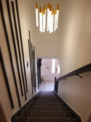 a view of a hallway with wooden floor and a window