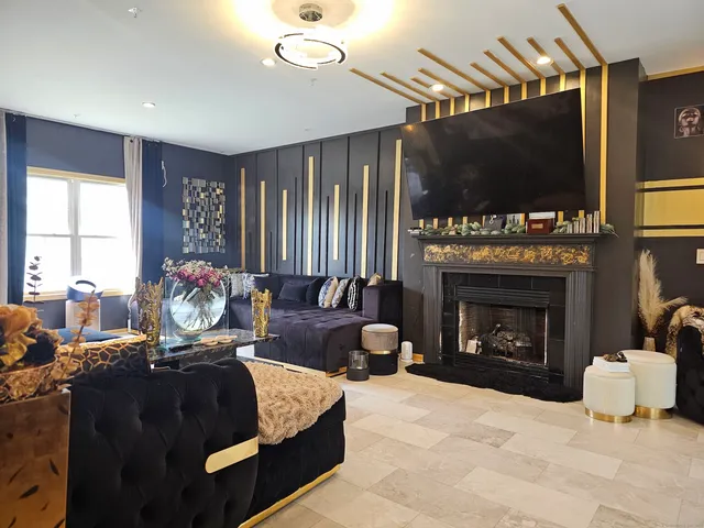 a living room with furniture a large window and a flat screen tv