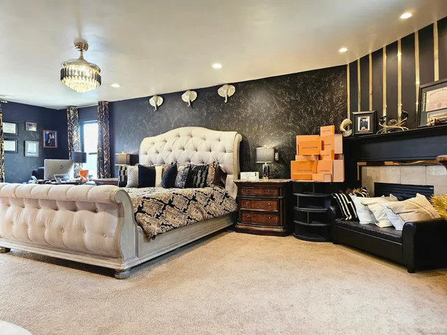 a bedroom with furniture and a large window