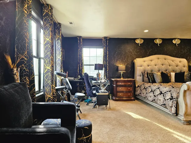 a bed room with furniture and a large window