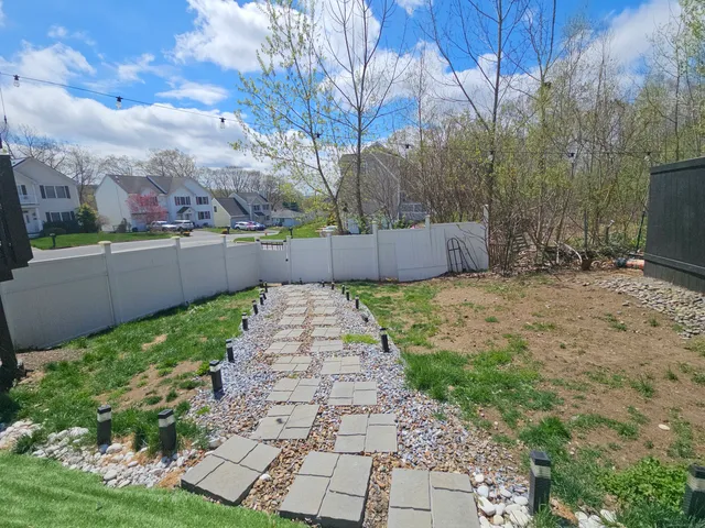 a view of a chairs and deck in the backyard