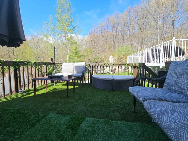 a view of a wooden deck and a backyard