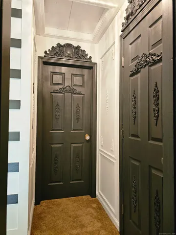 a view of a hallway with wooden floor and staircase