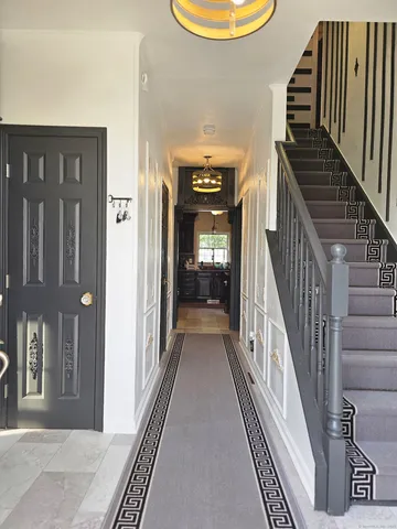 a view of a hallway with wooden floor and windows