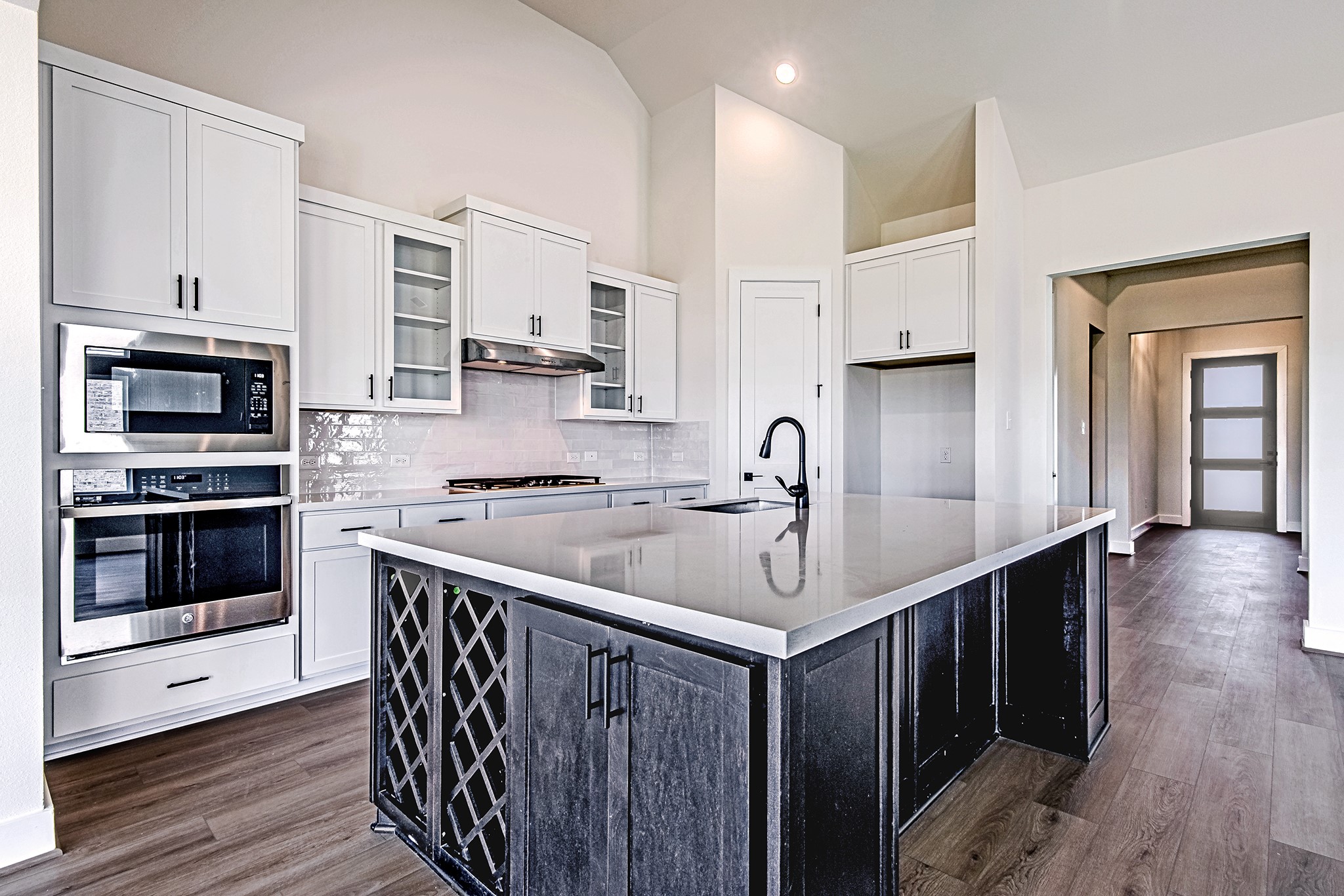 157 Peninsula Point Drive Montgomery, TX 77356 - Photo 6 of 33 a kitchen with stainless steel appliances sink stove microwave and cabinets