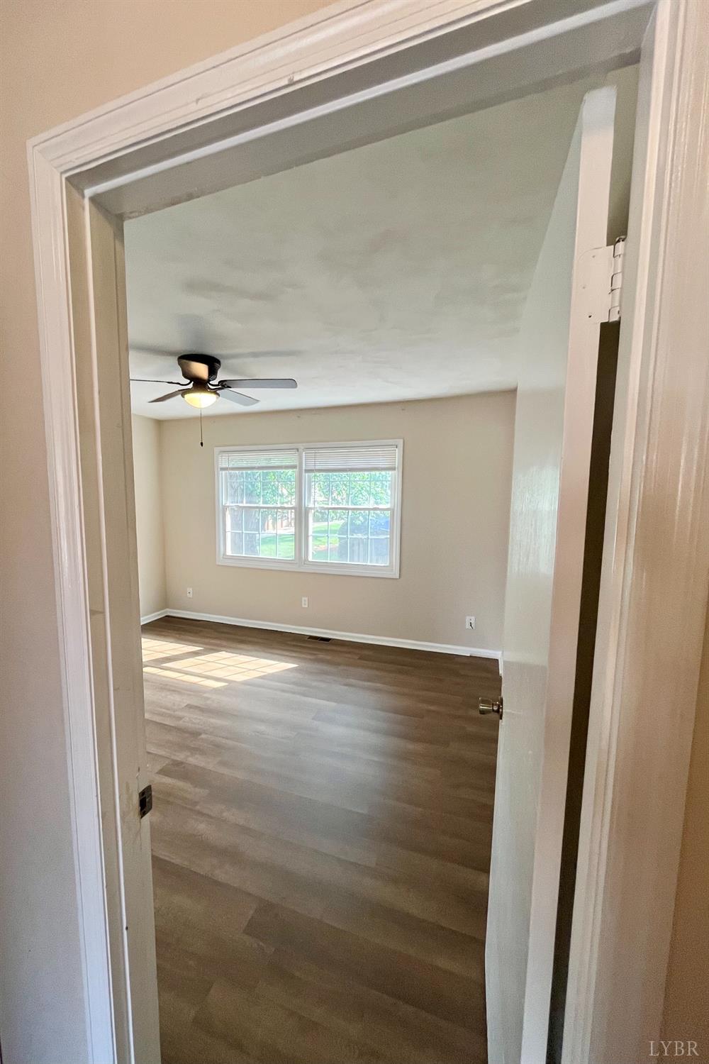 3101 Link Road, Unit 36 Lynchburg, VA 24503 - Photo 25 of 39 a view of an empty room with wooden floor and a window