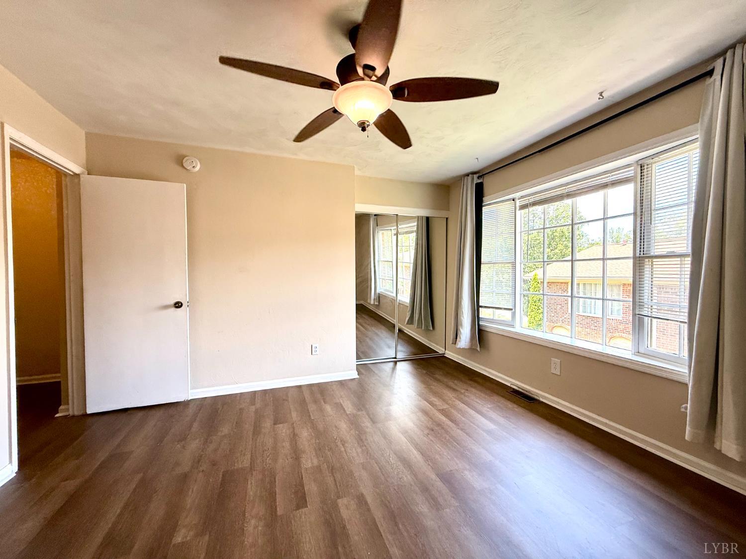 3101 Link Road, Unit 36 Lynchburg, VA 24503 - Photo 33 of 39 a view of an empty room with wooden floor and a window