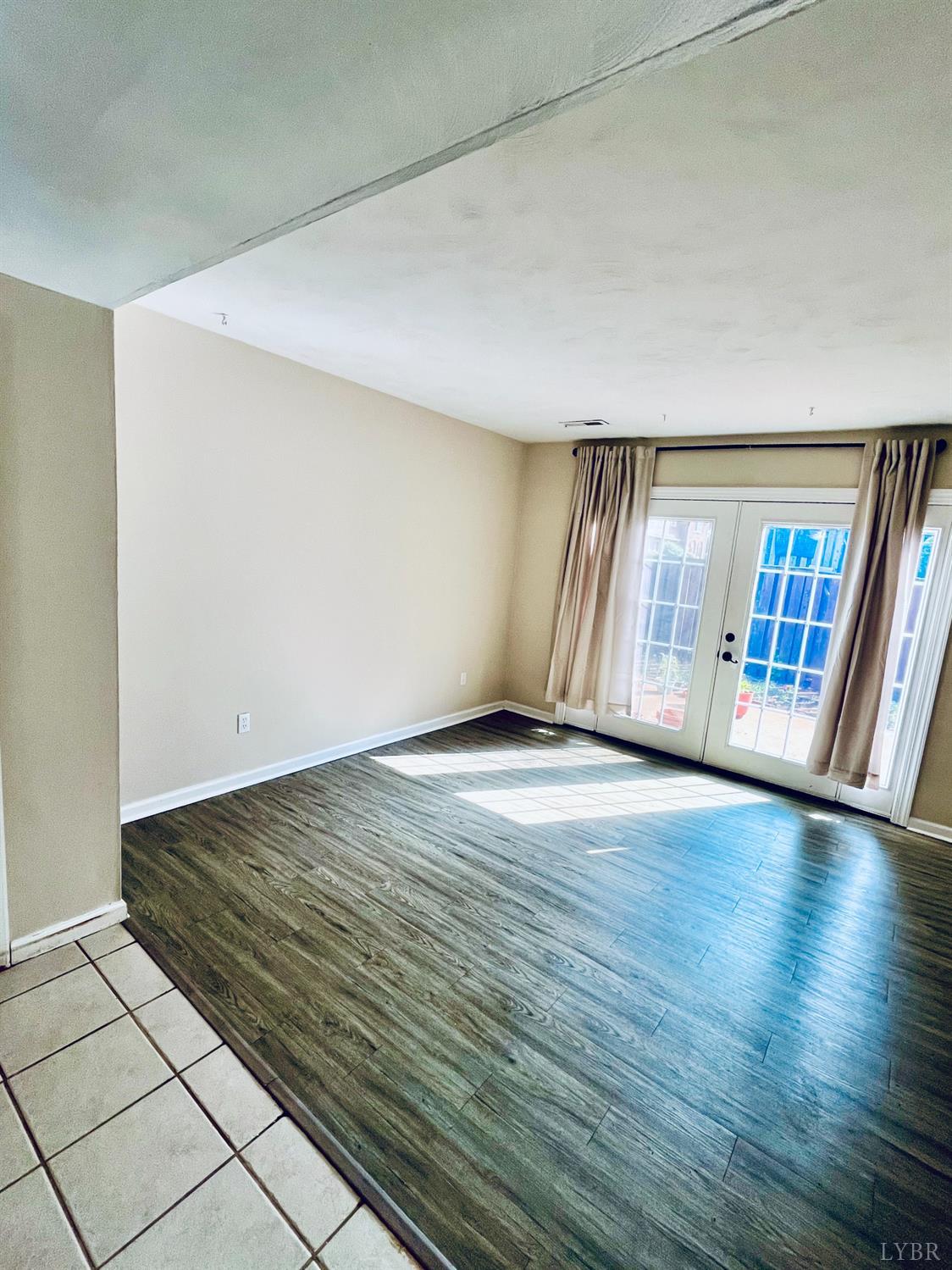 3101 Link Road, Unit 36 Lynchburg, VA 24503 - Photo 7 of 39 an empty room with wooden floor and windows
