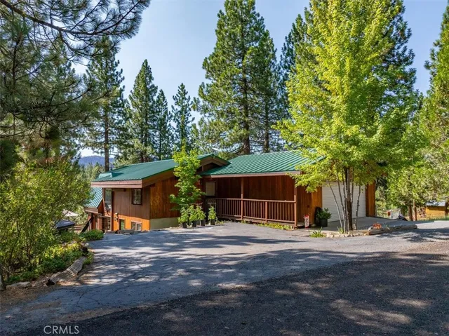 a front view of house with yard and trees