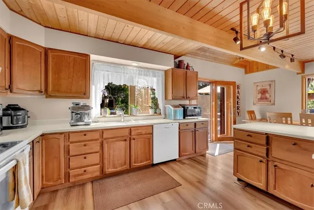 a kitchen with white cabinets and sink
