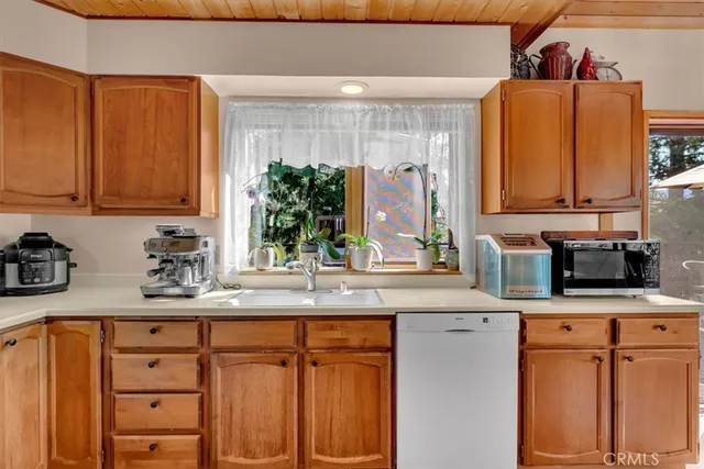 a kitchen with stainless steel appliances granite countertop a sink a stove and cabinets