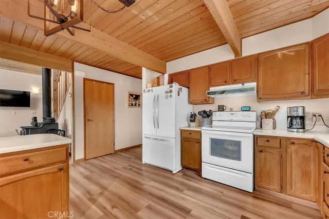 a kitchen with a stove a refrigerator and a sink