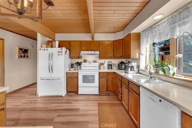 a kitchen with refrigerator and cabinets