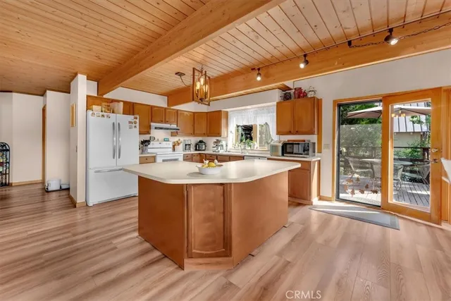 a kitchen with stainless steel appliances granite countertop a sink a stove and a wooden floors