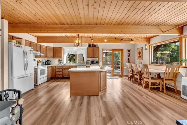 a living room with stainless steel appliances kitchen island granite countertop furniture and a kitchen view