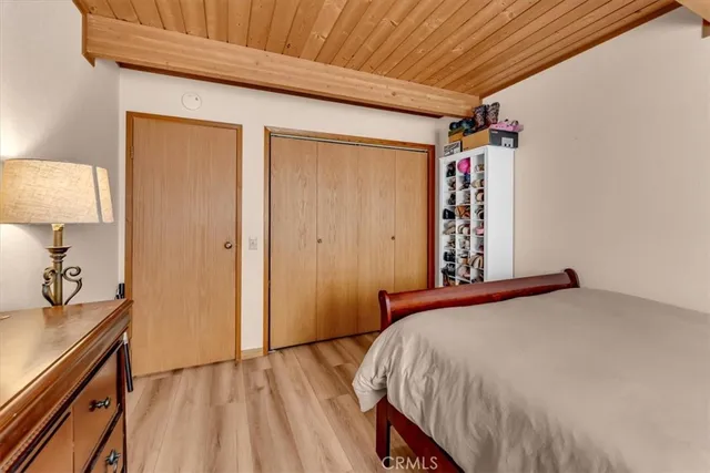 a bedroom with a bed and a dresser