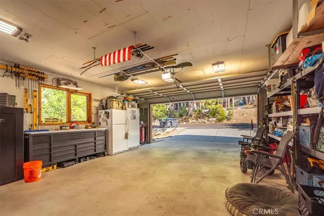 a room with lots of white furniture and a window