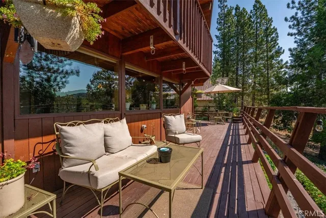 a view of a chairs and table on the balcony