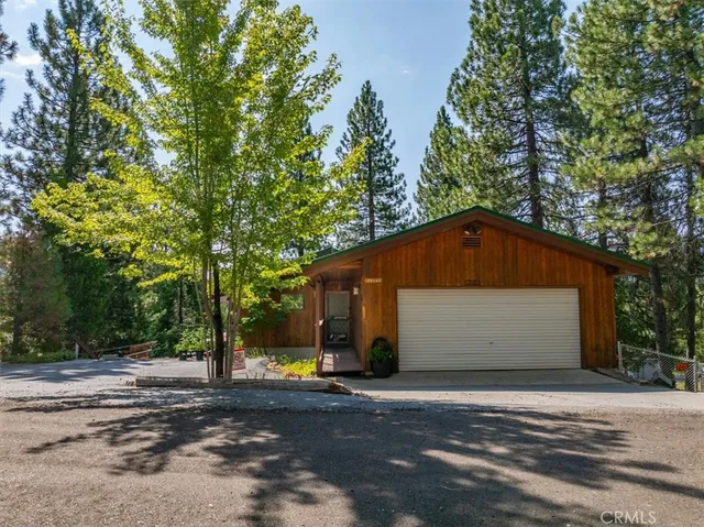 a front view of house with yard and trees