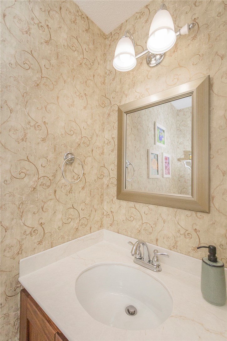 203 Oak Hollow Pendleton, SC 29670 - Photo 13 of 50 A compact and functional bathroom features a single vanity with an oval sink and a vanity light fixture.