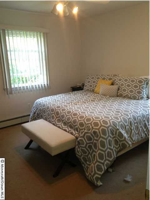 279 Cummings Avenue Long Branch, NJ 07740 - Photo 2 of 11 a bedroom with a bed and a window
