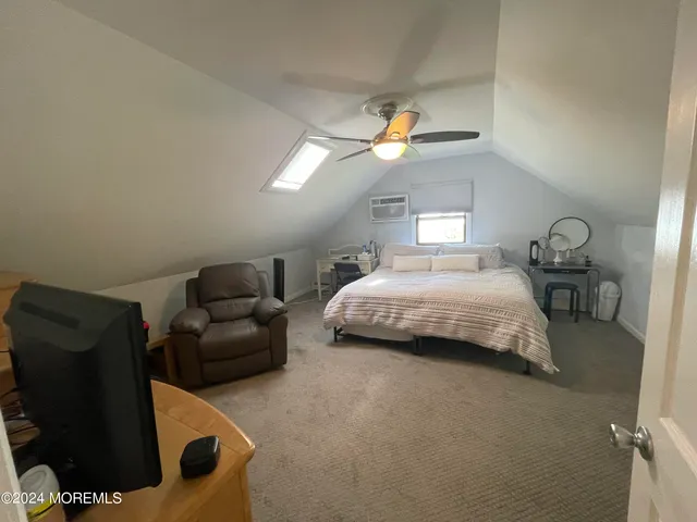 a bedroom with bed and window