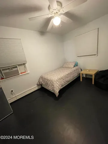 a bedroom with a bed and a ceiling fan