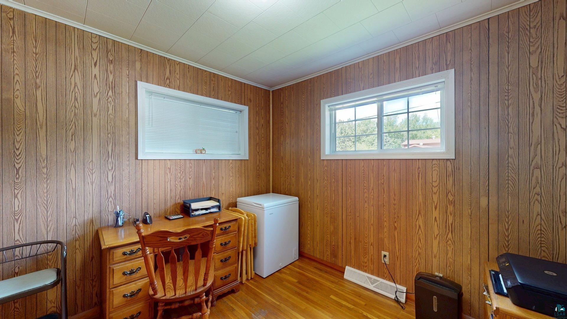 10614 Moose Lake Road Orr, MN 55771 - Photo 23 of 44 Wood paneling throughout the room, complemented by wood-finish flooring