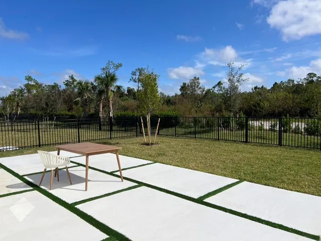a view of a swimming pool with a yard